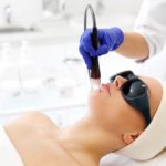 A woman in a beauty salon during a laser treatment