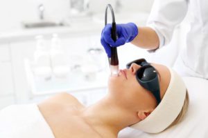 A woman in a beauty salon during a laser treatment