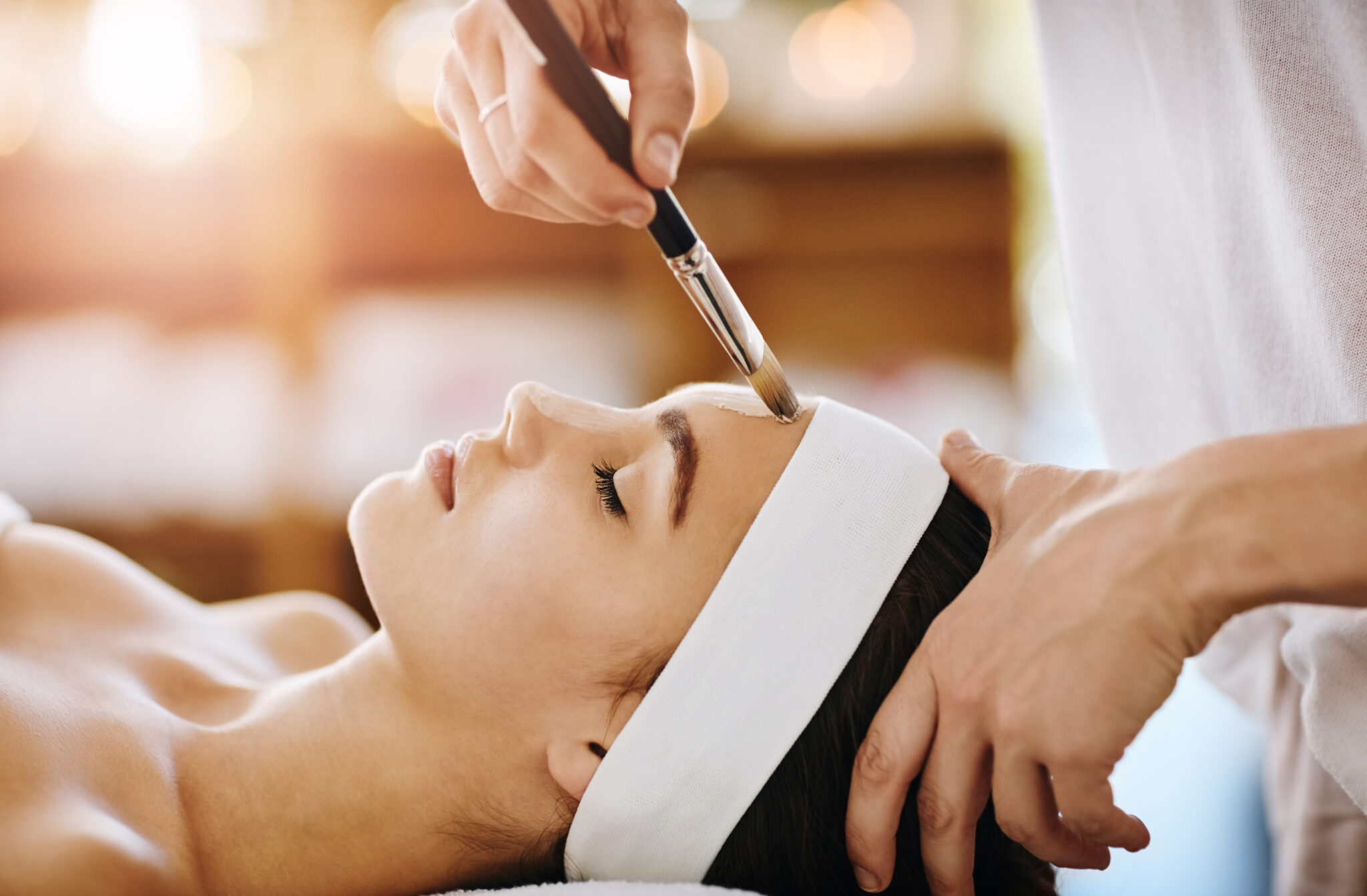Woman receiving chemical peel treatment on her forehead
