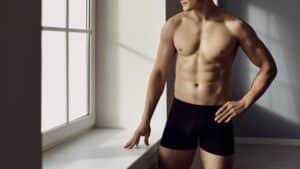 Man with toned body shows off his torso following TruSculpt treatment to eliminate stubborn fat